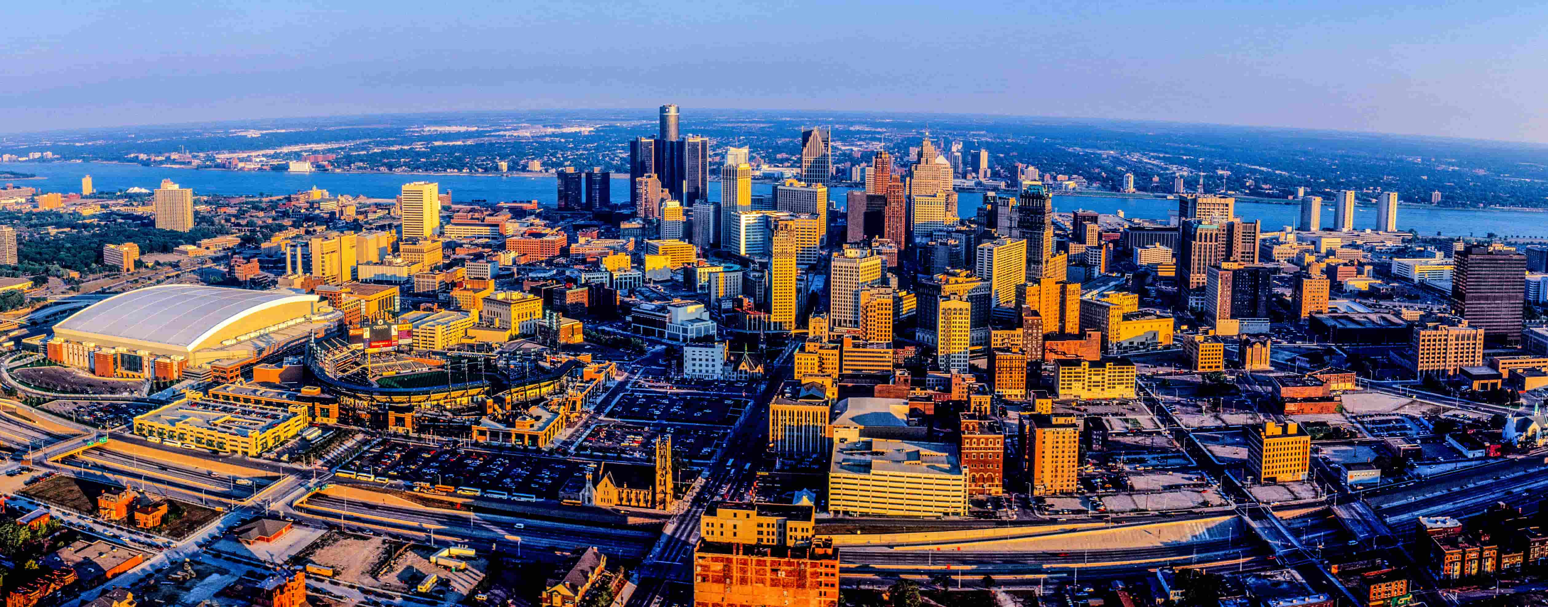 Panoramic view of the Detroit riverfront, with downtown in the center and Canada in the background