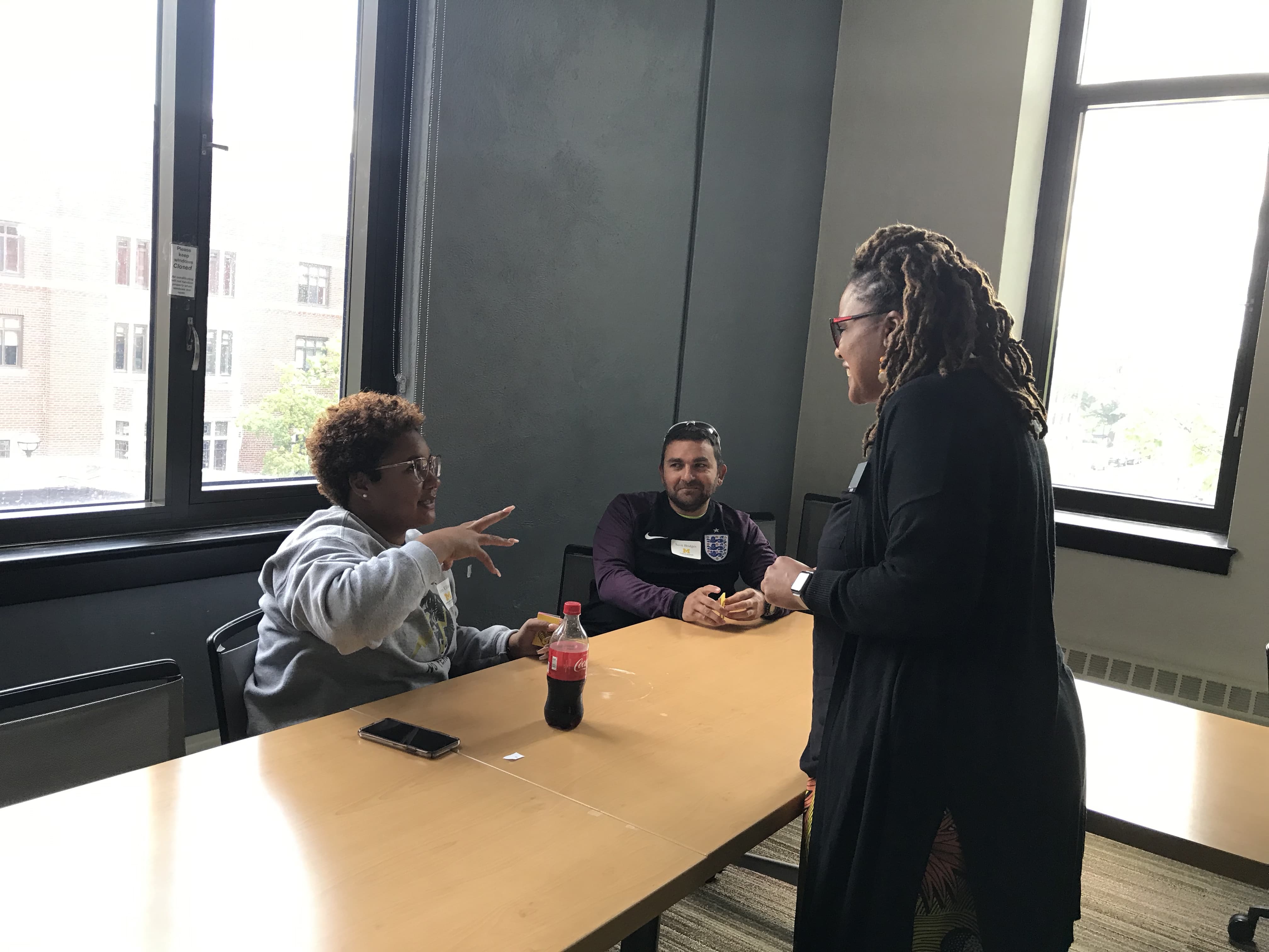 Maisie Gholson in conversation with two doctoral students