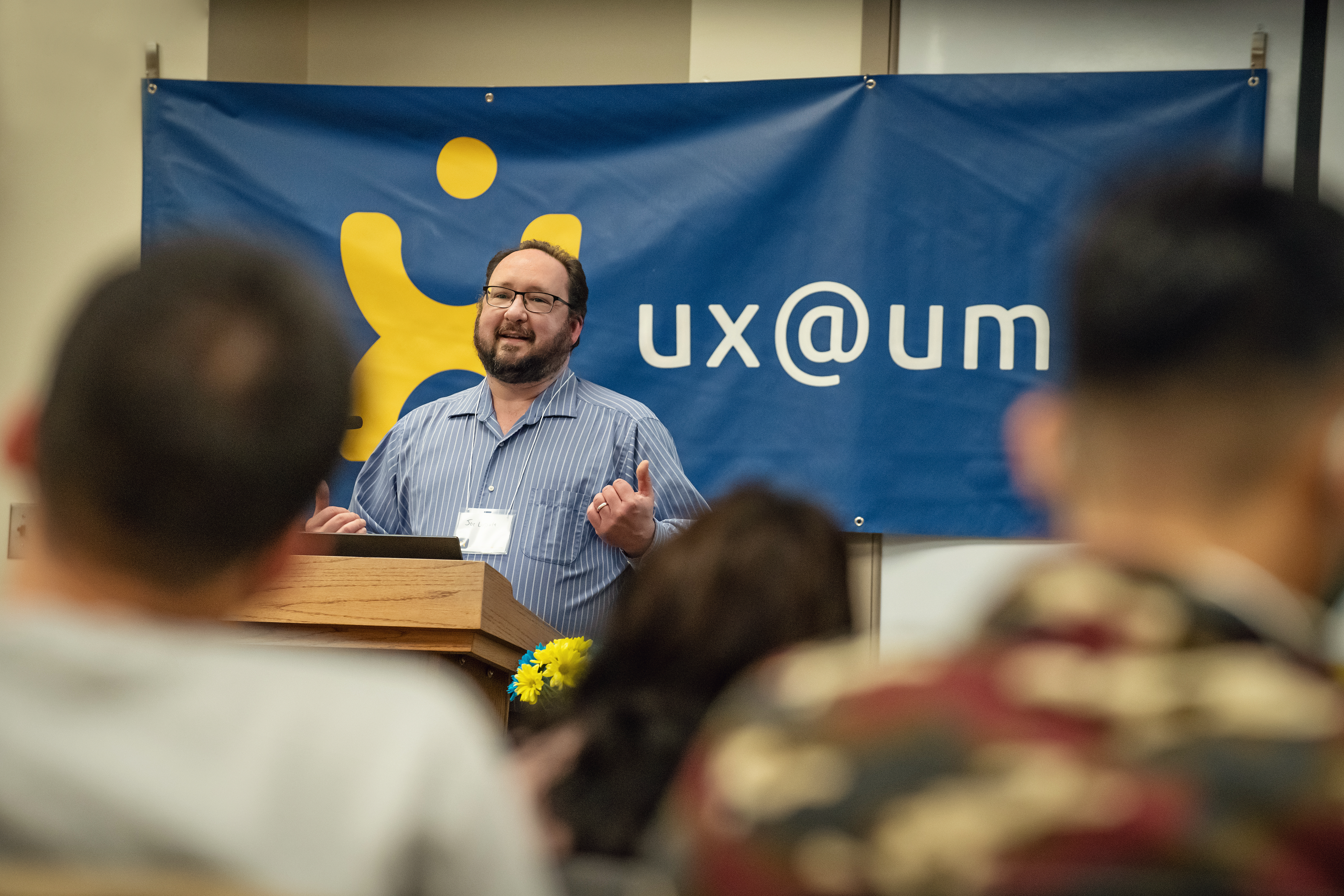 Person at podium presenting to group of people