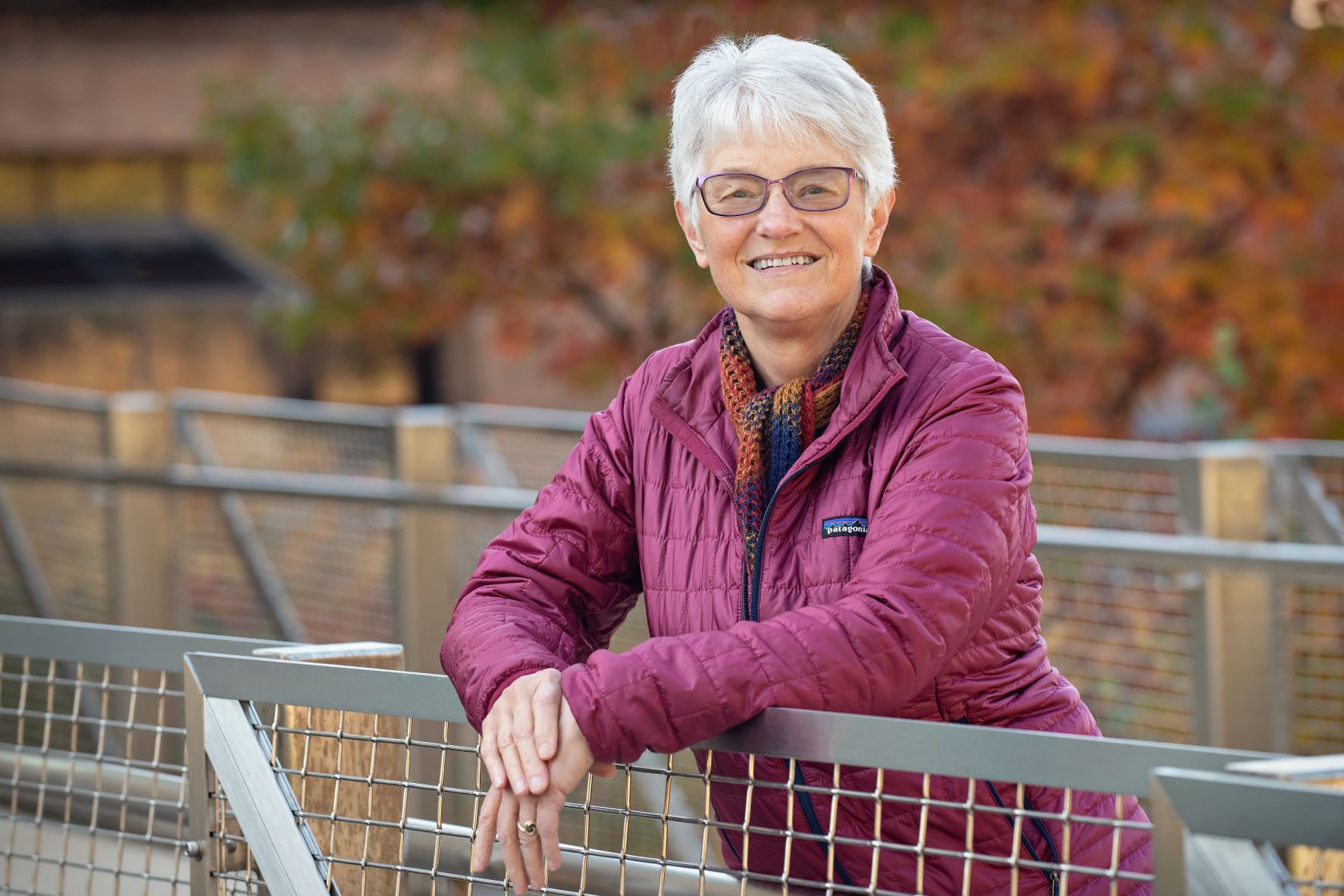 Portrait of Patricia King pausing while on a walk in nature.