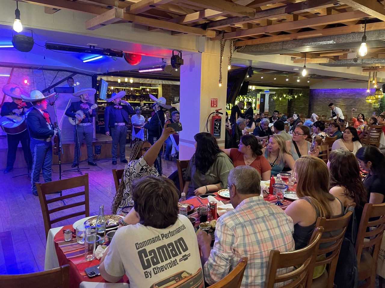 ELD interns sit at the dinner table and watch a mariachi performance at a restaurant in Mexico City.