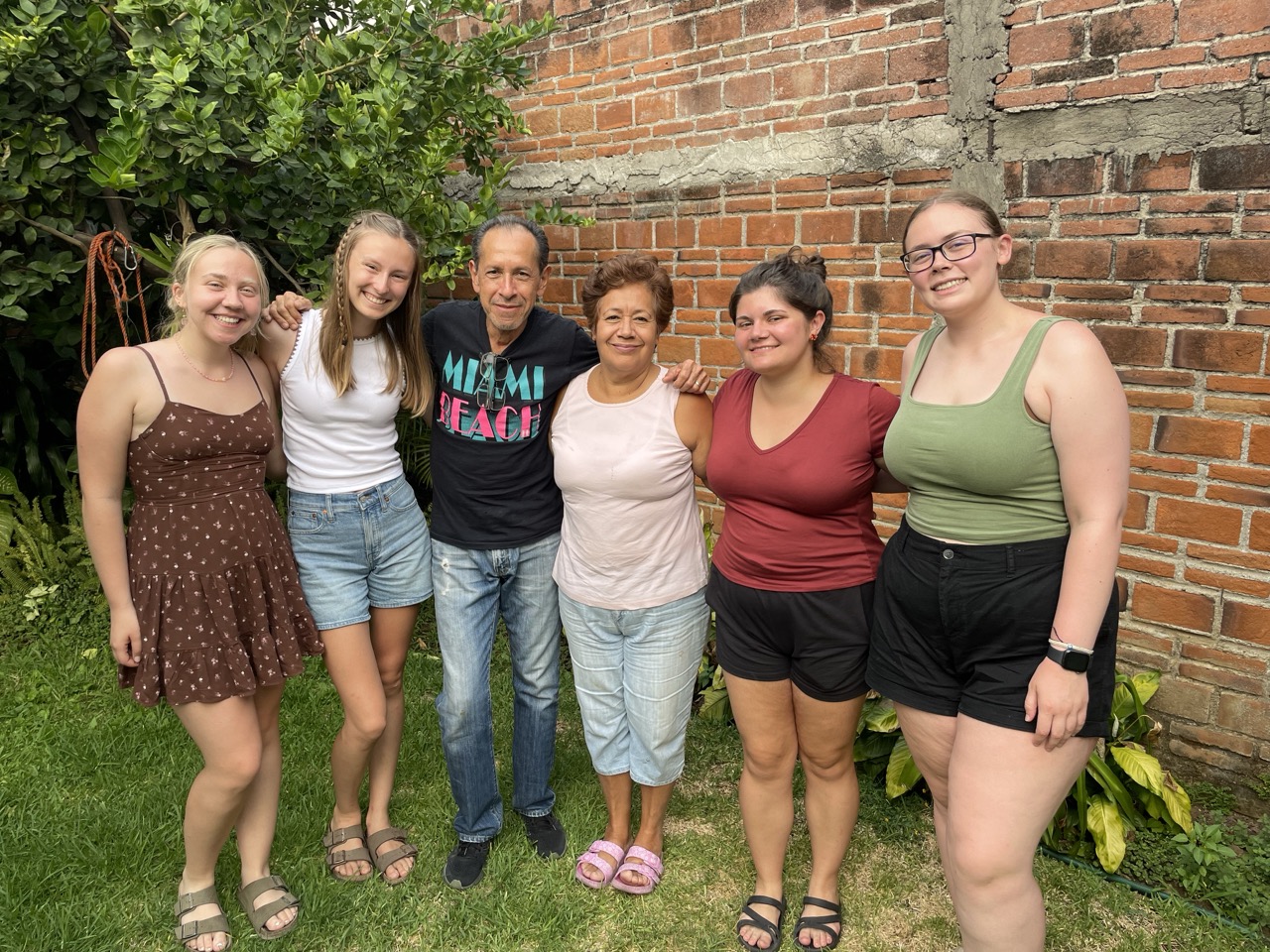 Teaching interns pose for a photo with their host family