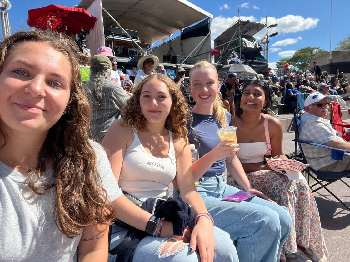 Four LEAPS students smile from their seats at the Detroit Jazz Festival