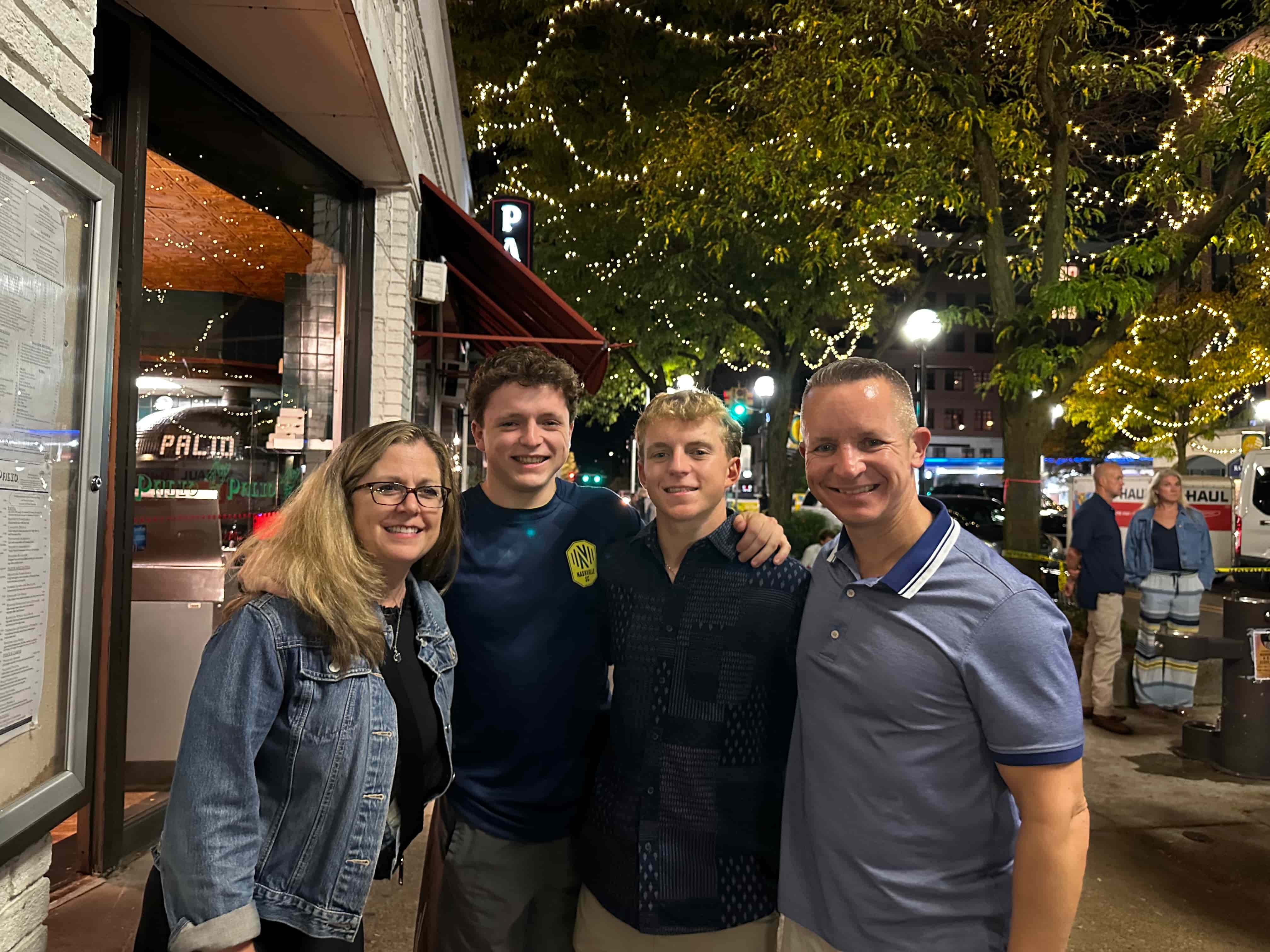 Tyler Barrett poses smiling with his family