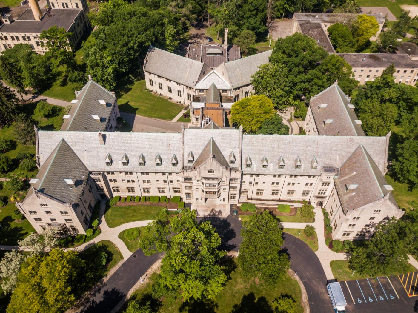 Aerial shot of large, stately collegiate hall called Madame Cadillac. 