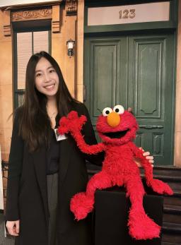 Ying Xu with Elmo during a visit to Sesame Workshop