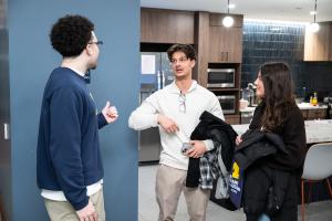 A current LEAPS student chats with two people in a kitchenette on the Marygrove campus 