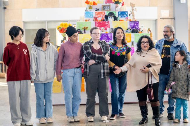 LEAPS students and dia de muertos organizers in front of the ofrenda 