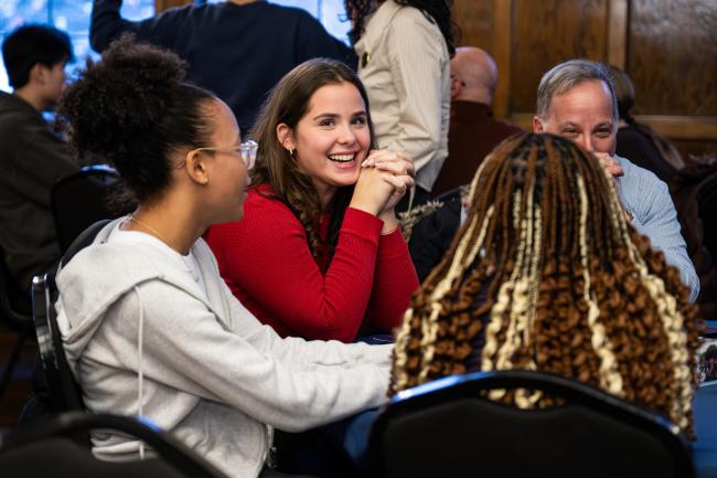 Three prospective LEAPS students sit at a table and discuss their interest at the winter 2026 LEAPS expo in Detroit