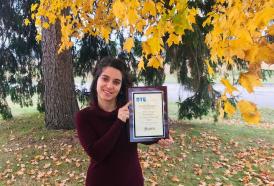 Rachel Bomphray holding DTE Award