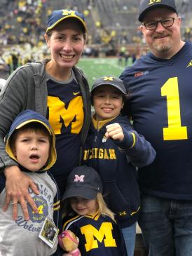 The Opdyke family poses for a photo inside Michigan Stadium