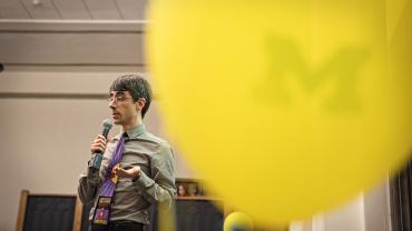 Outspoken Event - Speaker at the podium with yellow balloon