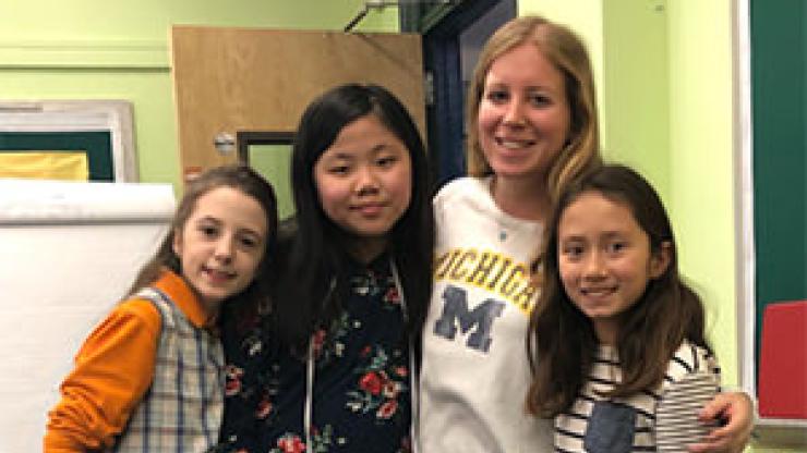 Image of a teacher and her students