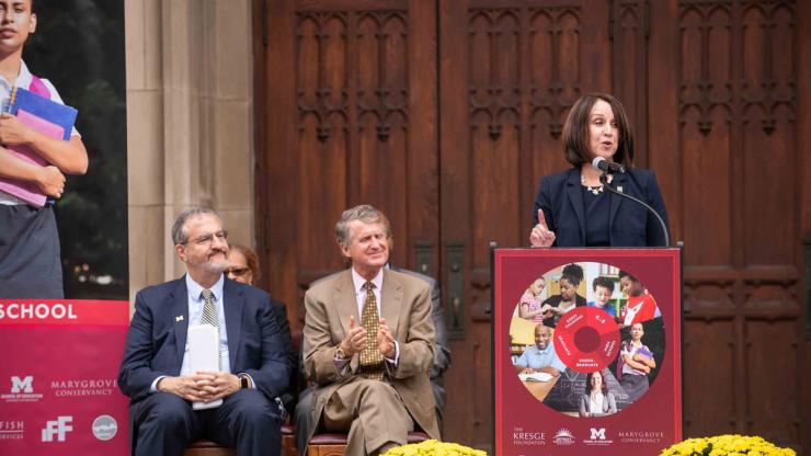 University of Michigan President Mark Schlissel watches on as School of Education Dean Elizabeth Moje gives a speech.