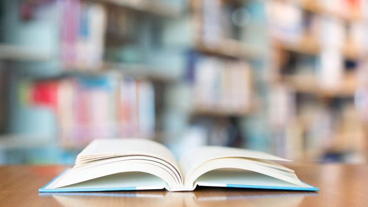 an open book laying on a table in a library