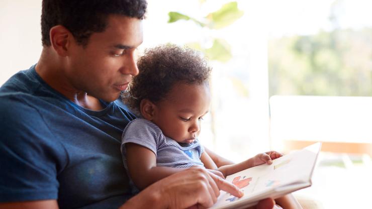 father reading to baby