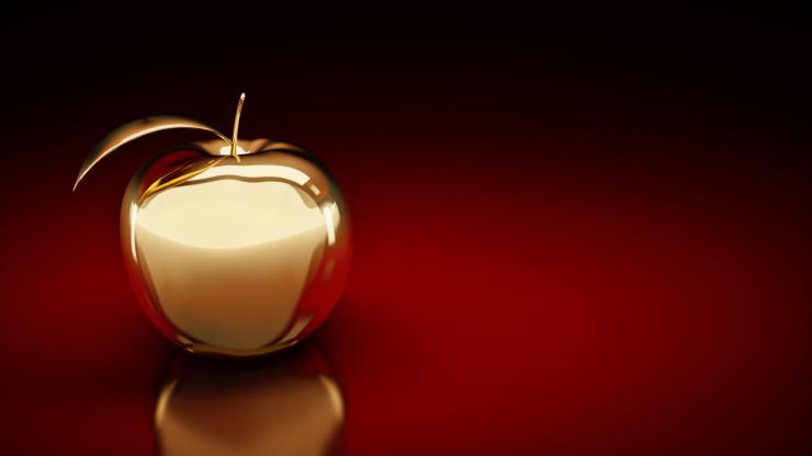 A golden apple on a red background