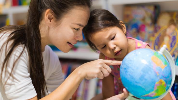 Teacher and child with globe