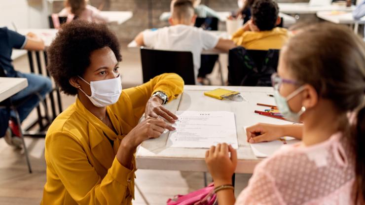 teacher and student with masks on