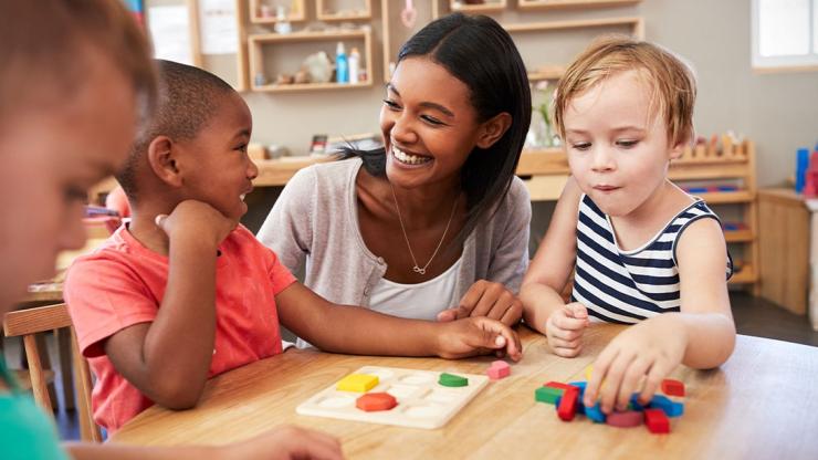 Preschool teacher working with children.