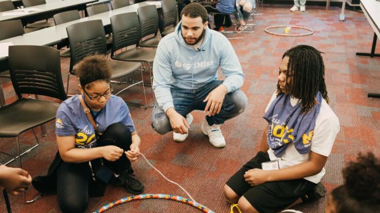 Teacher meeting with students in a circle.