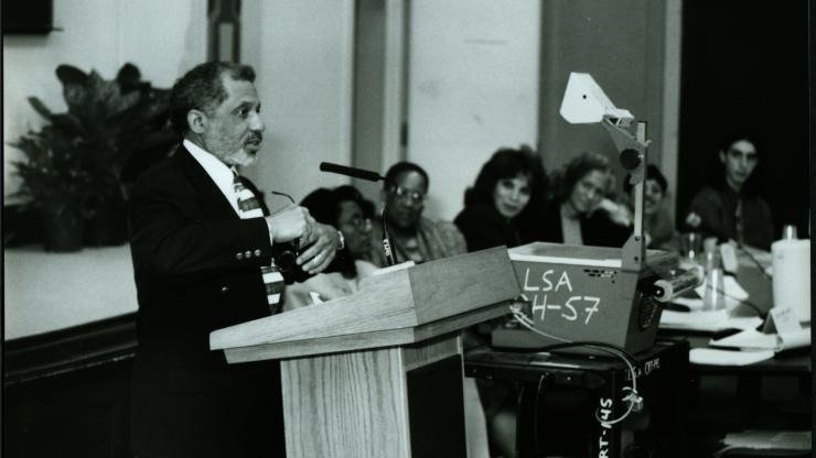 Black and white photo of Henry Meares speaking at a podium