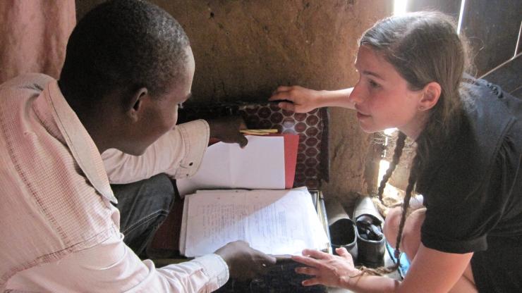 A student attending school in Kakuma Refugee Camp shows Michelle Bellino the suitcase where he keeps his schoolbooks.