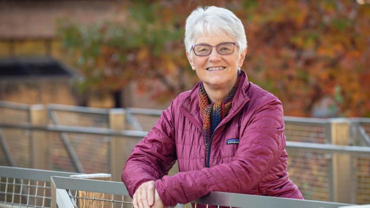 Portrait of Patricia King pausing while on a walk in nature.