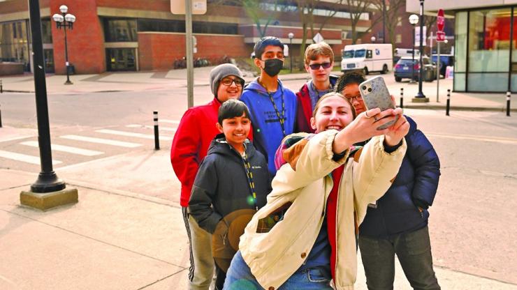 Several students pose for a selfie on Ann Arbor's Central Campus.