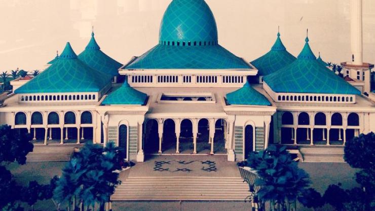 Al-Akbar National Mosque of Surabaya, East Java, Indonesia; the mosque has a distinctive blue central dome and spire that contrasts with white walls and columns.