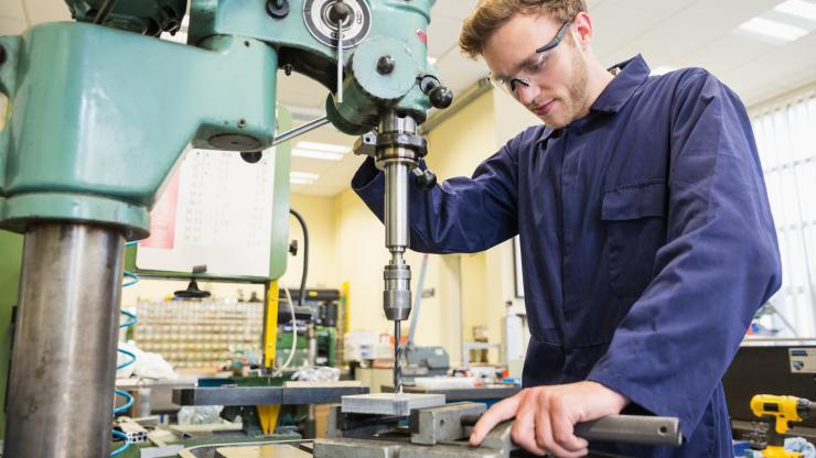 High school student using machinery