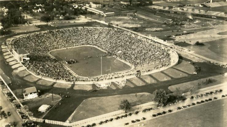 Aerial view of a football stadium filled with attendees.
