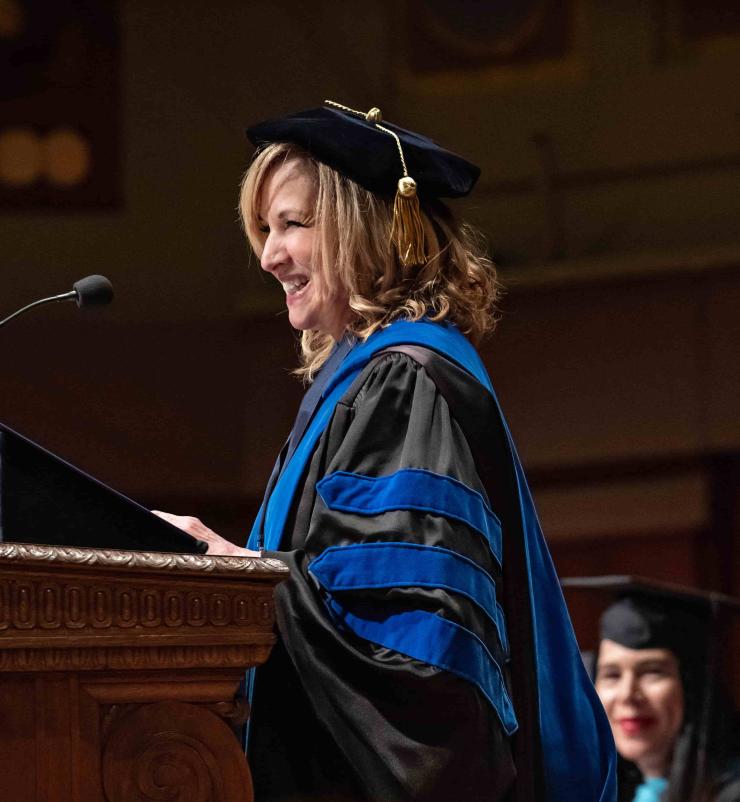 Dean Moje smiles warmly from the podium at the 2022 SOE Commencement ceremony.