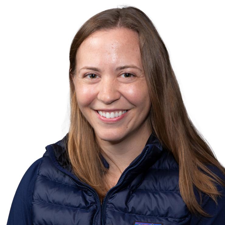 Image of smiling woman with shoulder length brown hair, wearing a black jacket