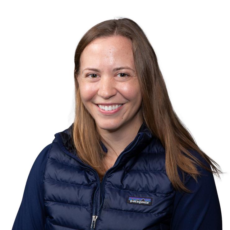 Image of smiling woman with shoulder length brown hair, wearing a black jacket