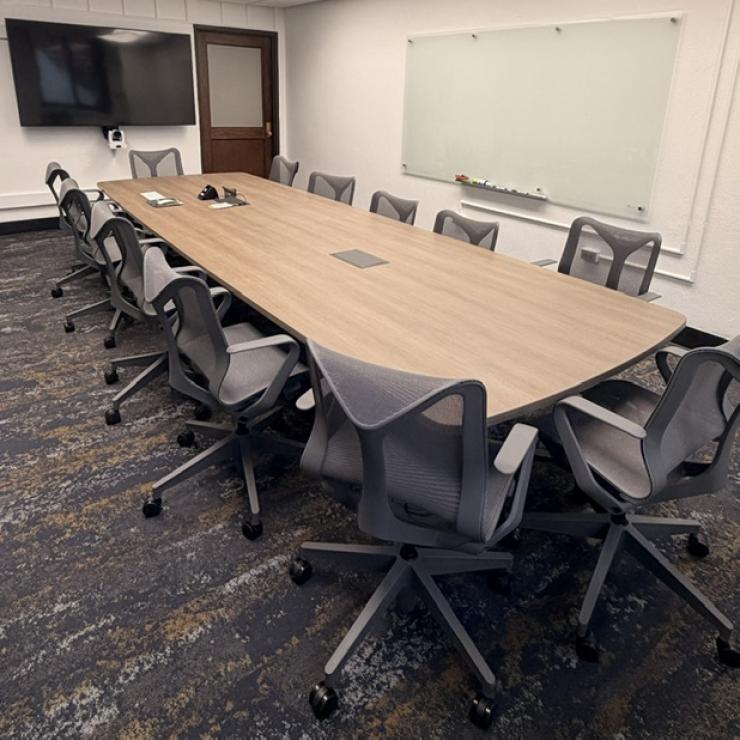 A room with a conference desk and chairs