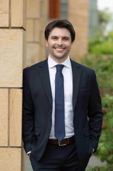 Alex Bercu stands and smiles