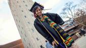 Spring 2019 graduate poses in front of Burton Memorial Tower