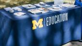 Flyers on a table in the courtyard of the School of Education during New Student Orientation