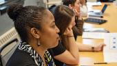 conference participants pensively listening to speaker off camera