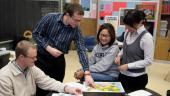 Photo of teachers discussing a map of the United StatesT