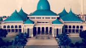 Al-Akbar National Mosque of Surabaya, East Java, Indonesia; the mosque has a distinctive blue central dome and spire that contrasts with white walls and columns.